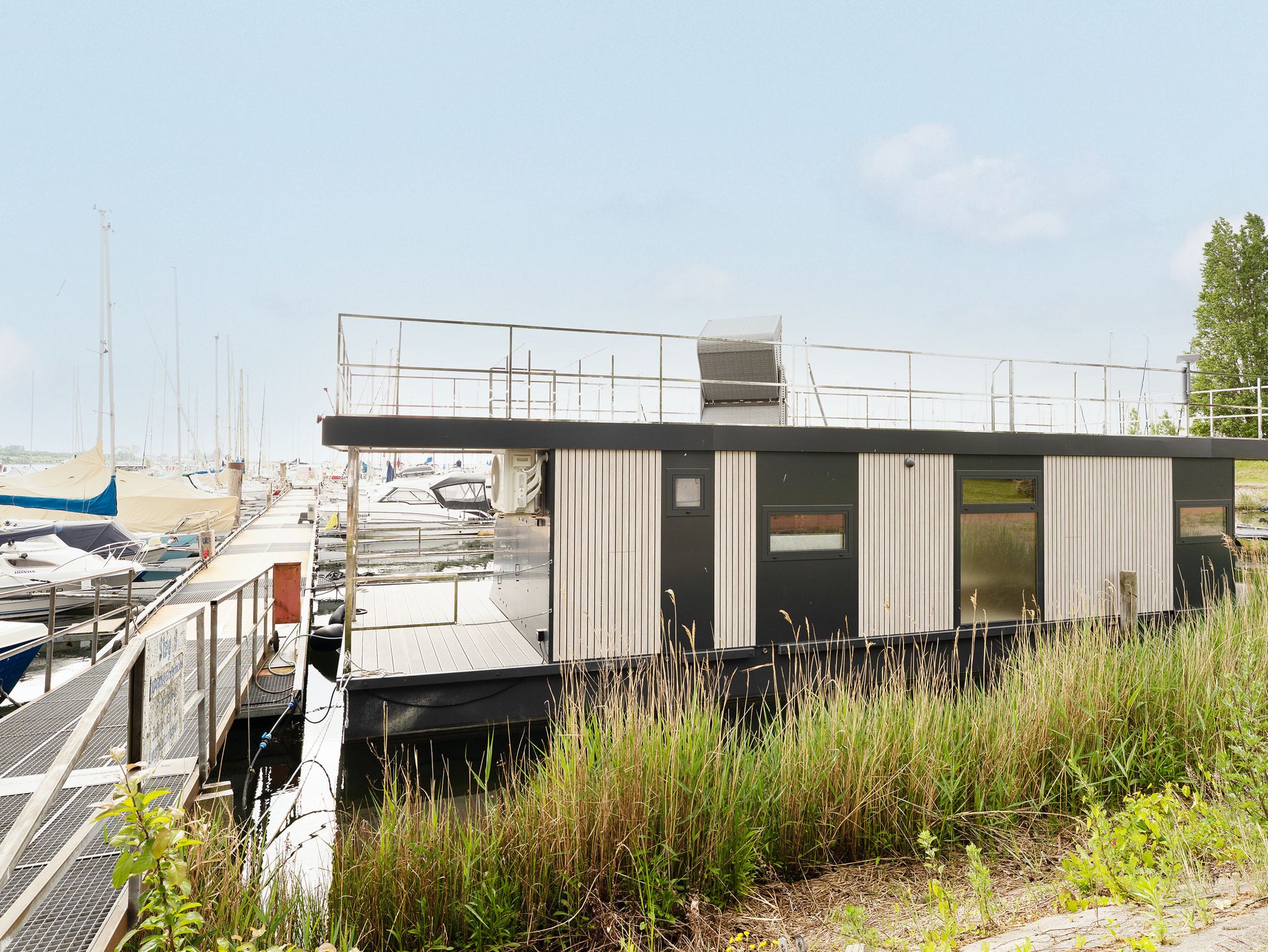 waterside home for sale moored in a European marina berth