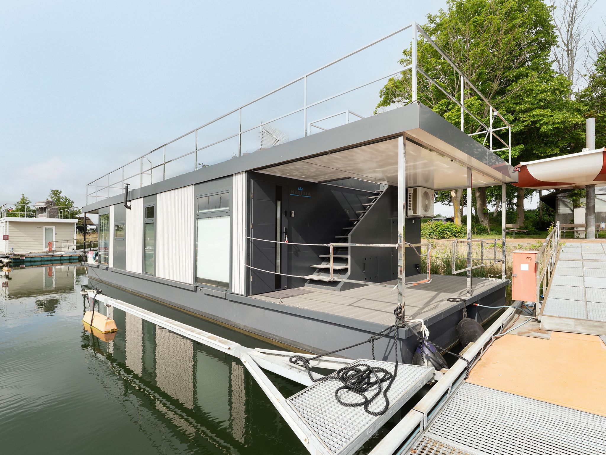 Buy waterfront home directly from manufacturer with available marina berths